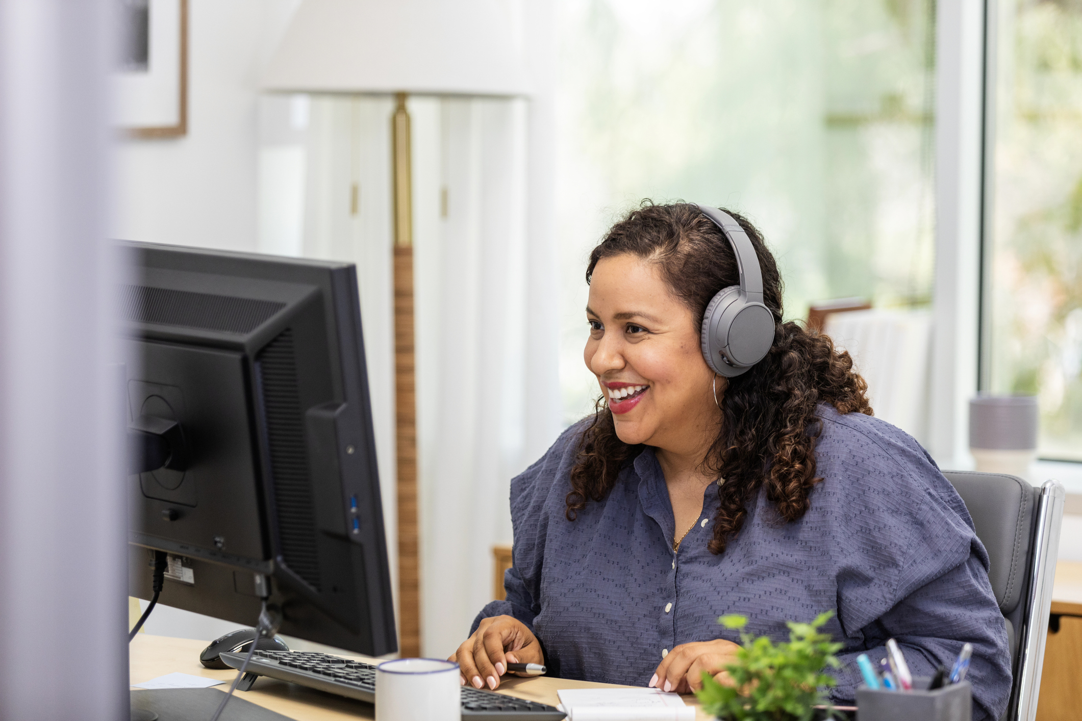 Woman sitting at desk looking at computer