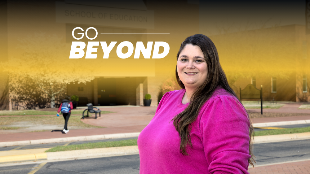 Ashley Anderson stands in front of the School of Education building on the UNCP campus. 