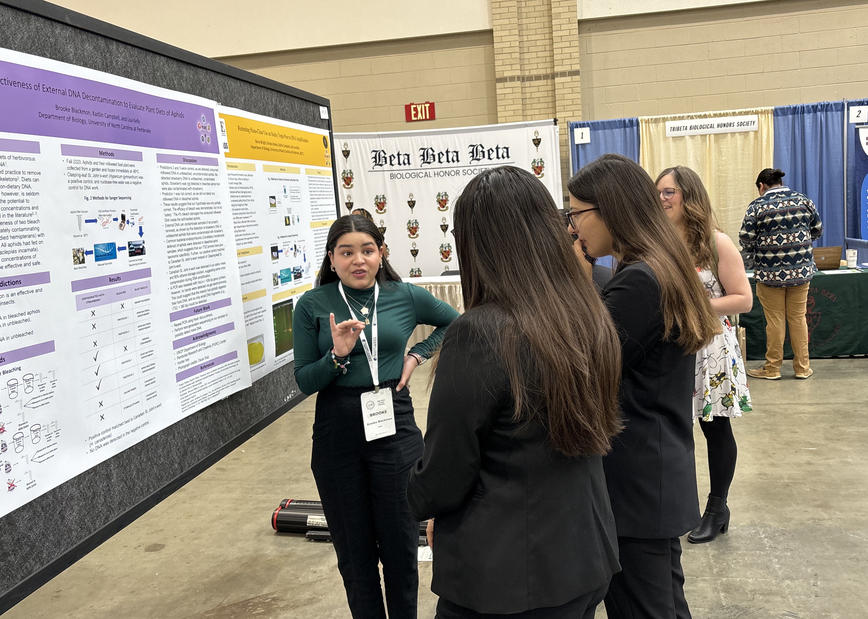 Brooke Blackmon speaking to ASB Conference attendees in front of her poster.