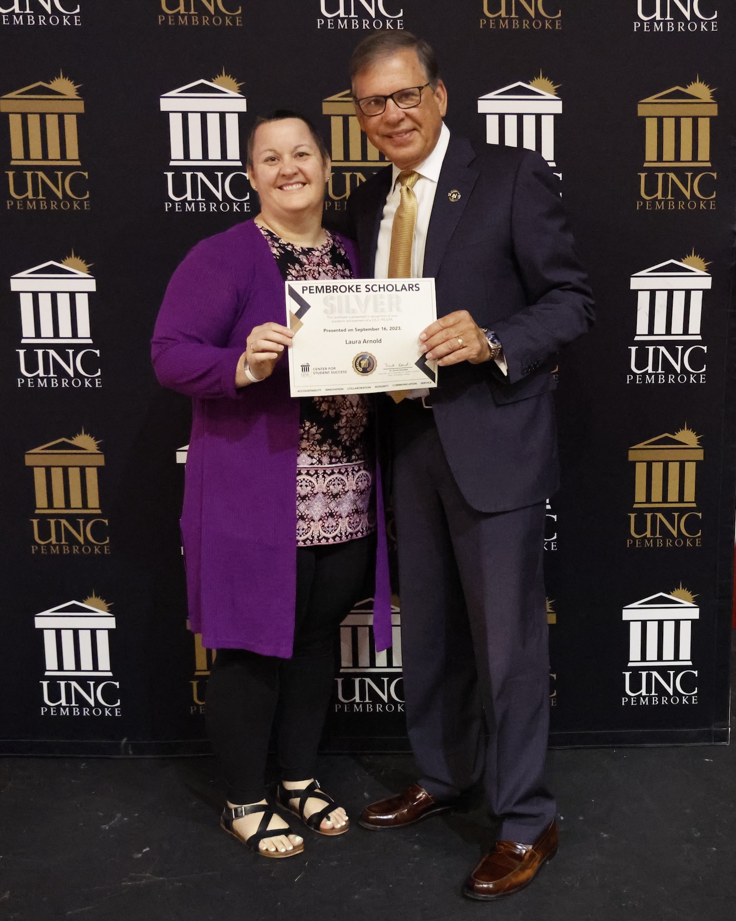 Chancellor Robin Gary Cummings presents Laura Arnold with the Silver Scholar Award at the 7th Annual Pembroke Scholars Achievement Ceremony.