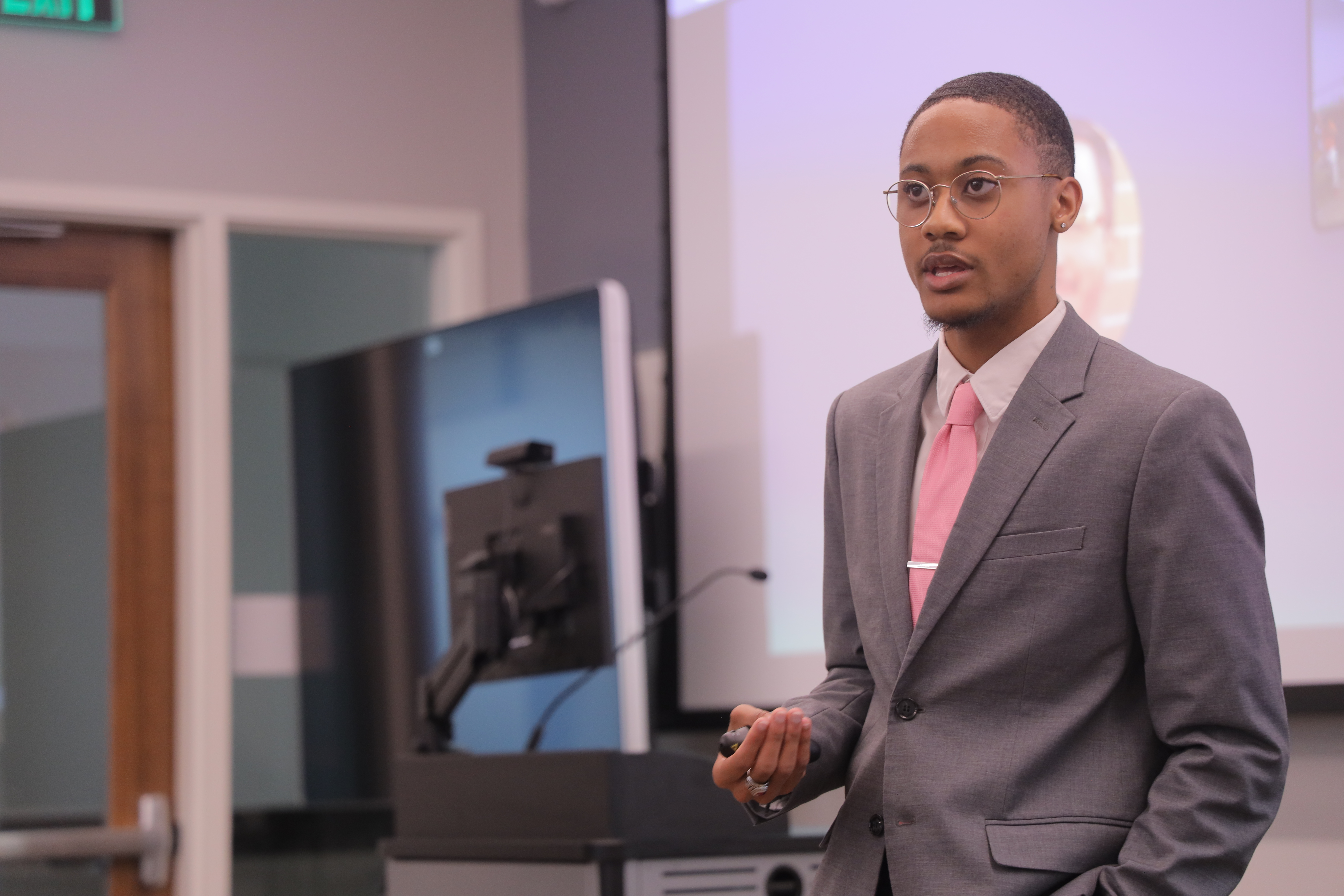A UNC Pembroke REACH Fellow speaks at a podium