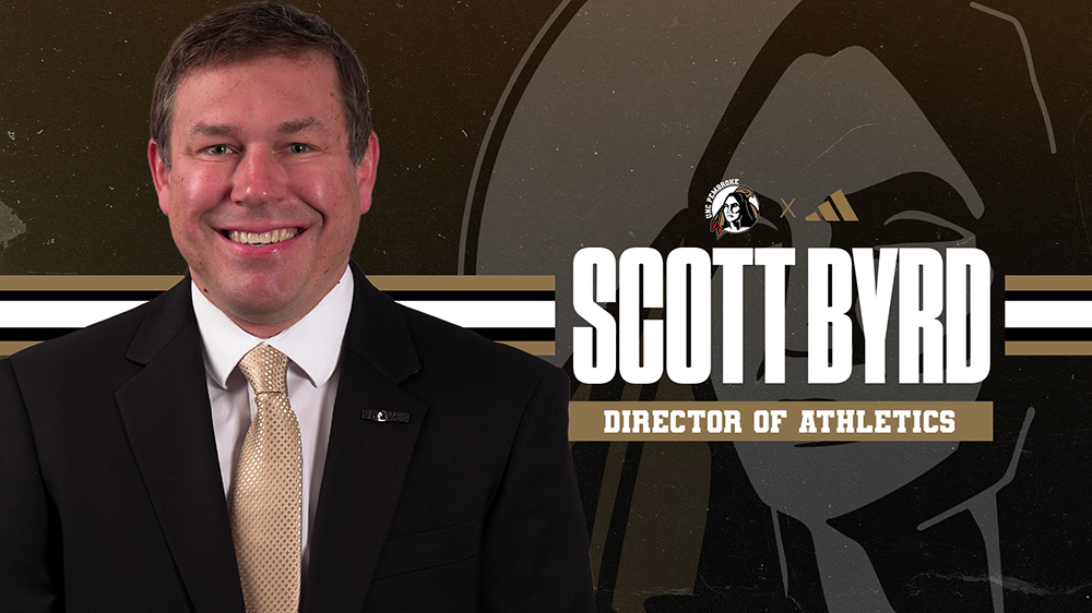 Scott Byrd, UNC Pembroke's new Director of Athletics, poses for an official announcement graphic featuring his name and title against a UNCP Braves branded background.