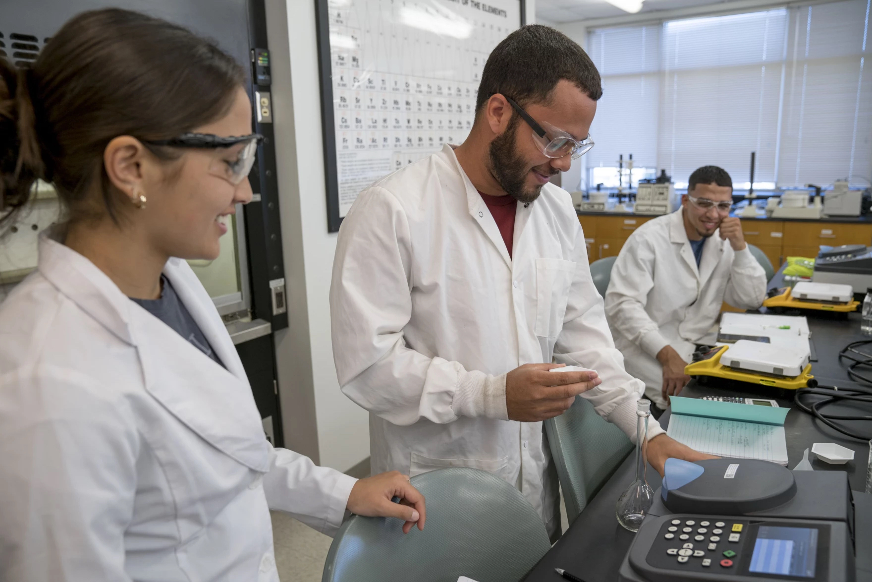 Students at UNC-Pembroke work with chemistry lab equipment. Photo by Willis Glassgow
