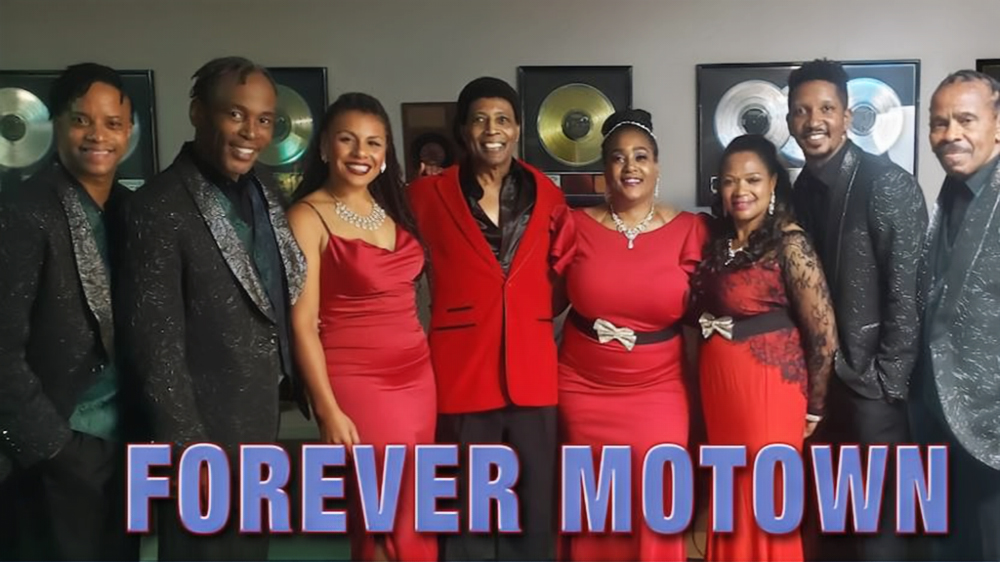 The Forever Motown ensemble poses together in formal attire in front of gold and platinum records, representing the all-star Motown celebration coming to the GPAC at UNC Pembroke on April 24.