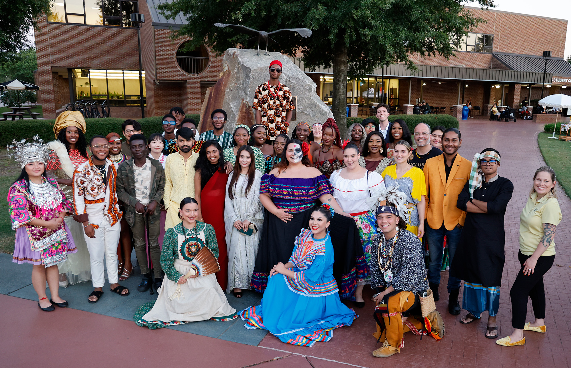 Students pose in their traditional garb during the Black and Gold event.