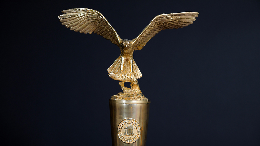 UNCP Mace - red-tailed hawk in gold atop a staff