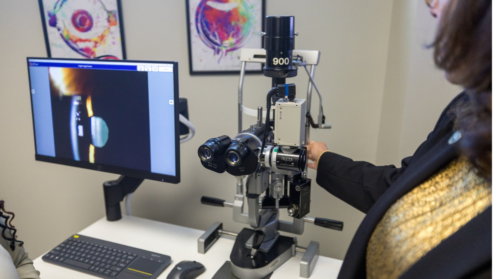 A faculty member demonstrates with optometic equipment in a lab at the Brave Health Center on the UNCP campus.