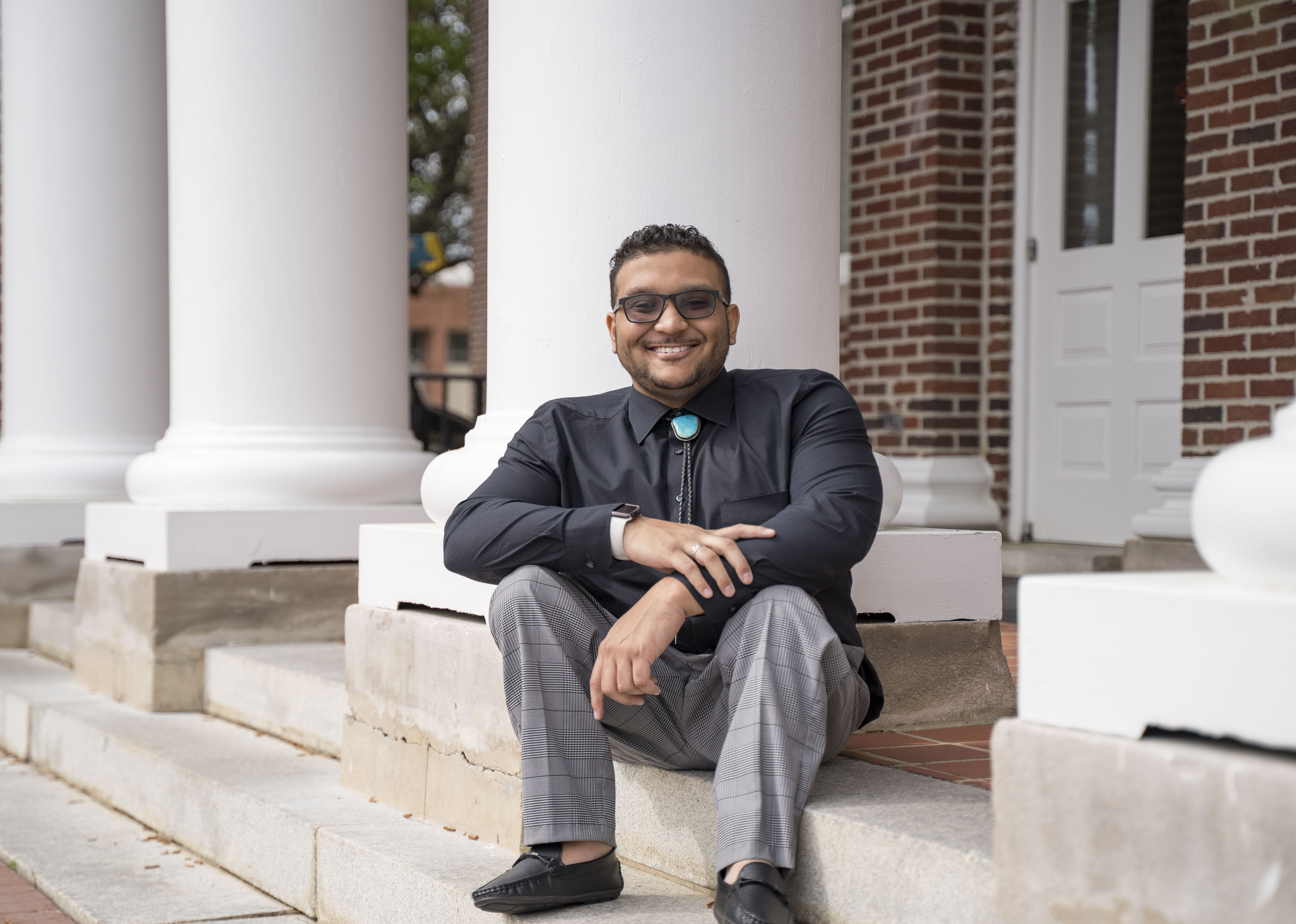 Benjamin sitting on the steps of Old Main