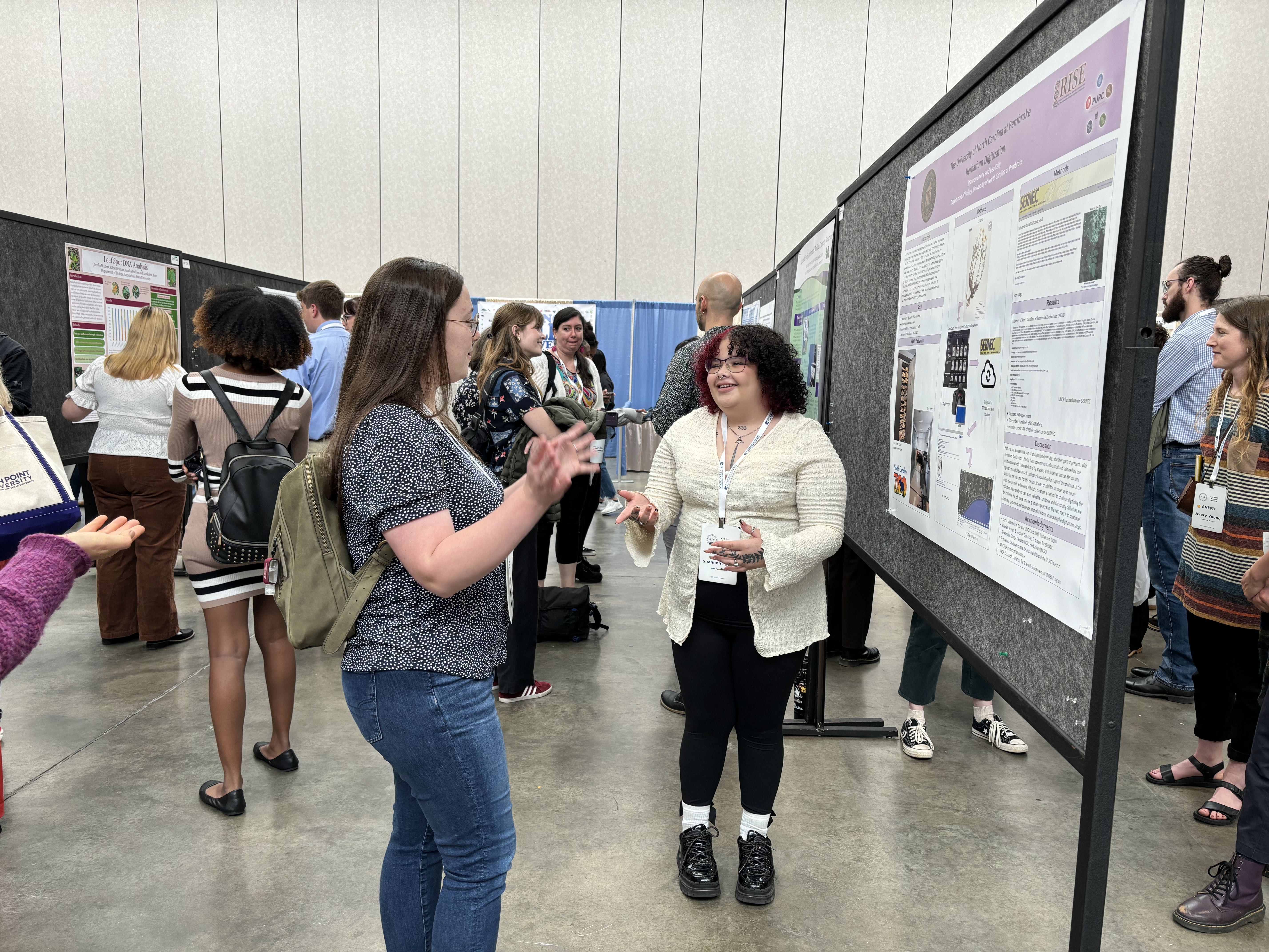 Shannon Lowry explains her reserach project to a passerby.