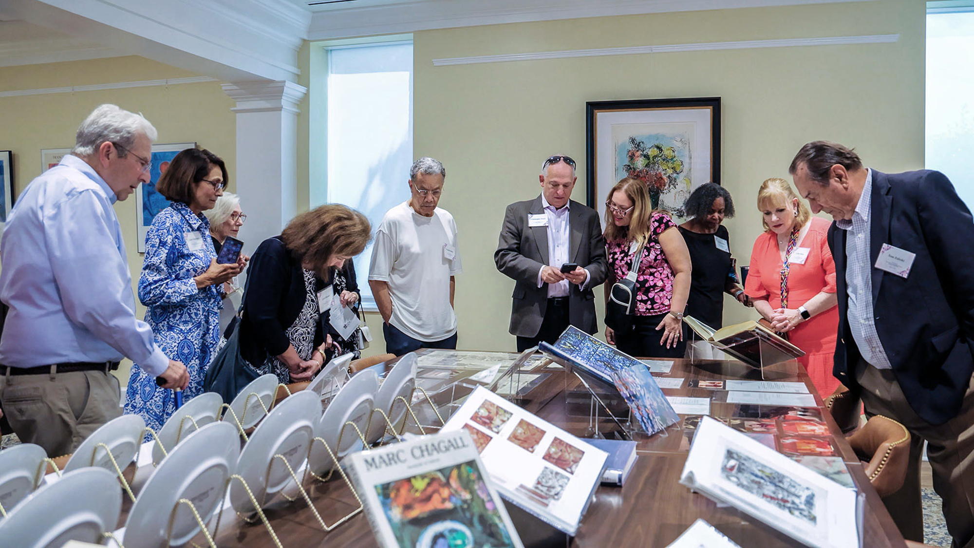 Visitors view artwork and other materials at the opening of the Vivian R. and Ralph Jacobson Special Collections room at UNCP.
