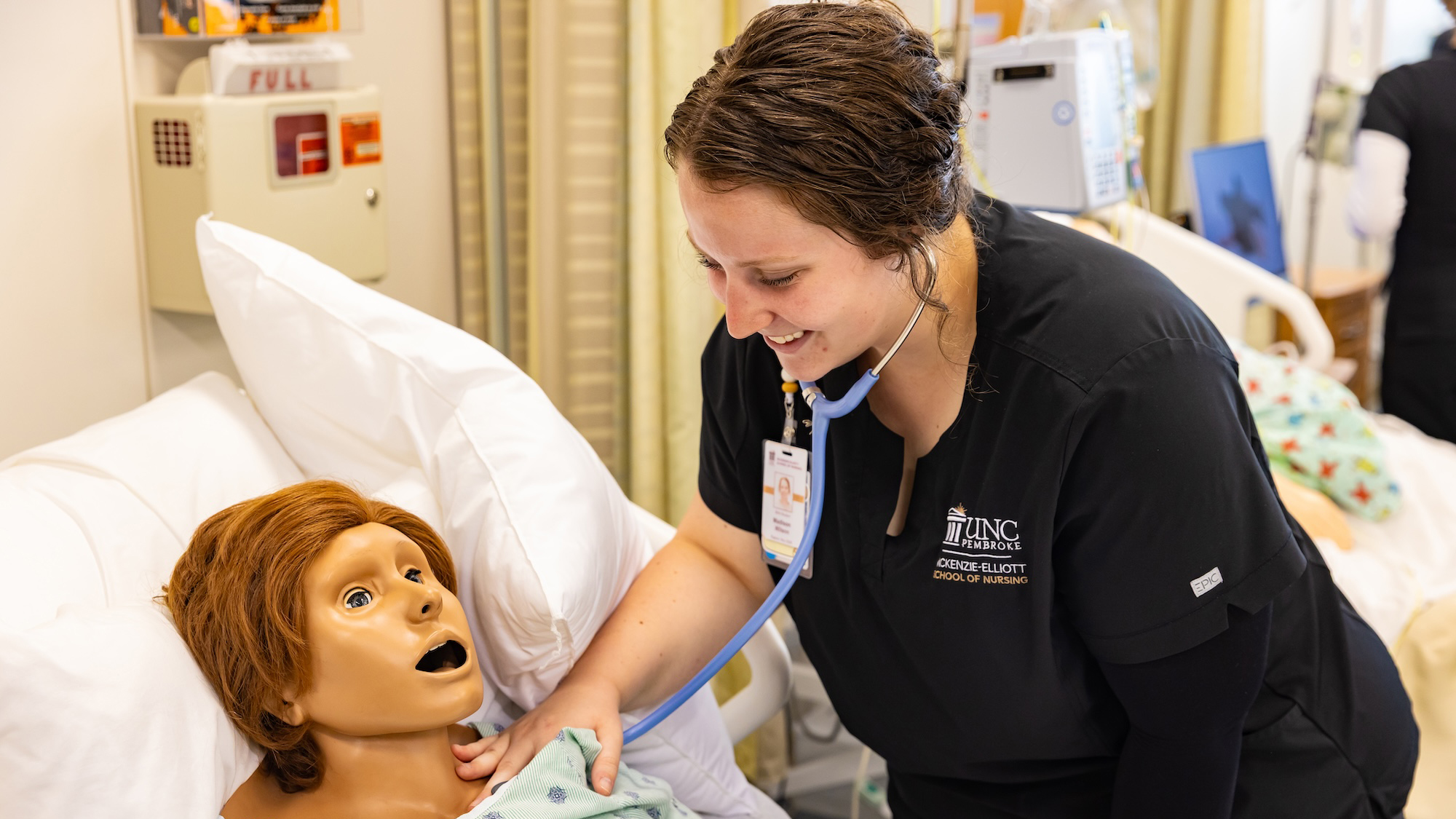 UNCP student with a dummy in the Clinical Learning Center
