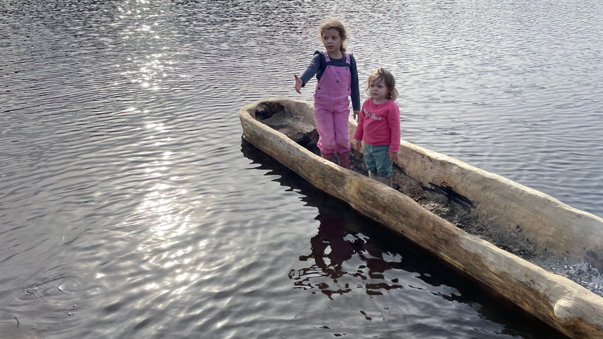 Children stand in the canoe