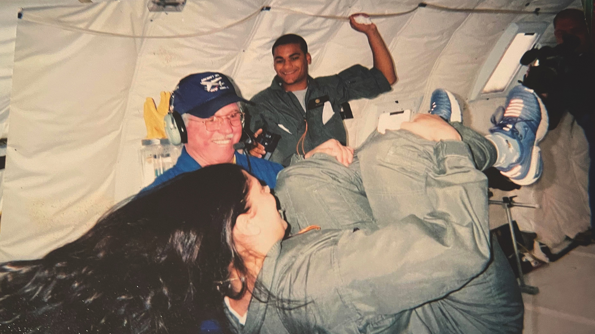 student spinning in weightlessness as teachers look on