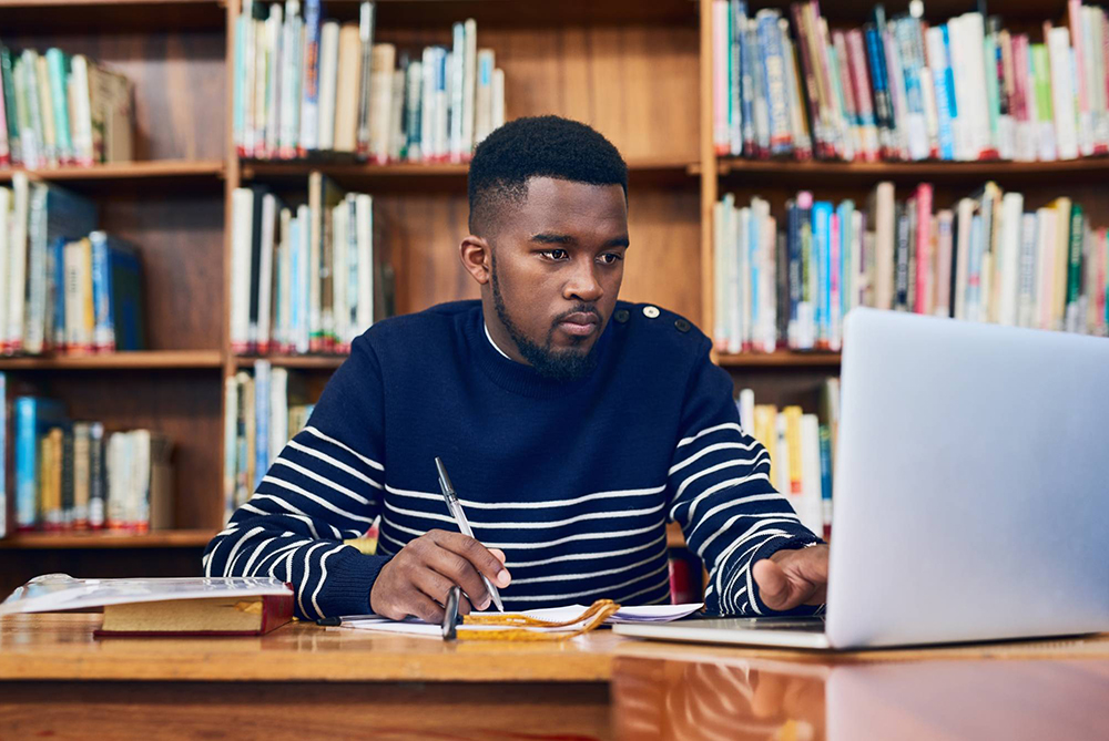 student in a library studying