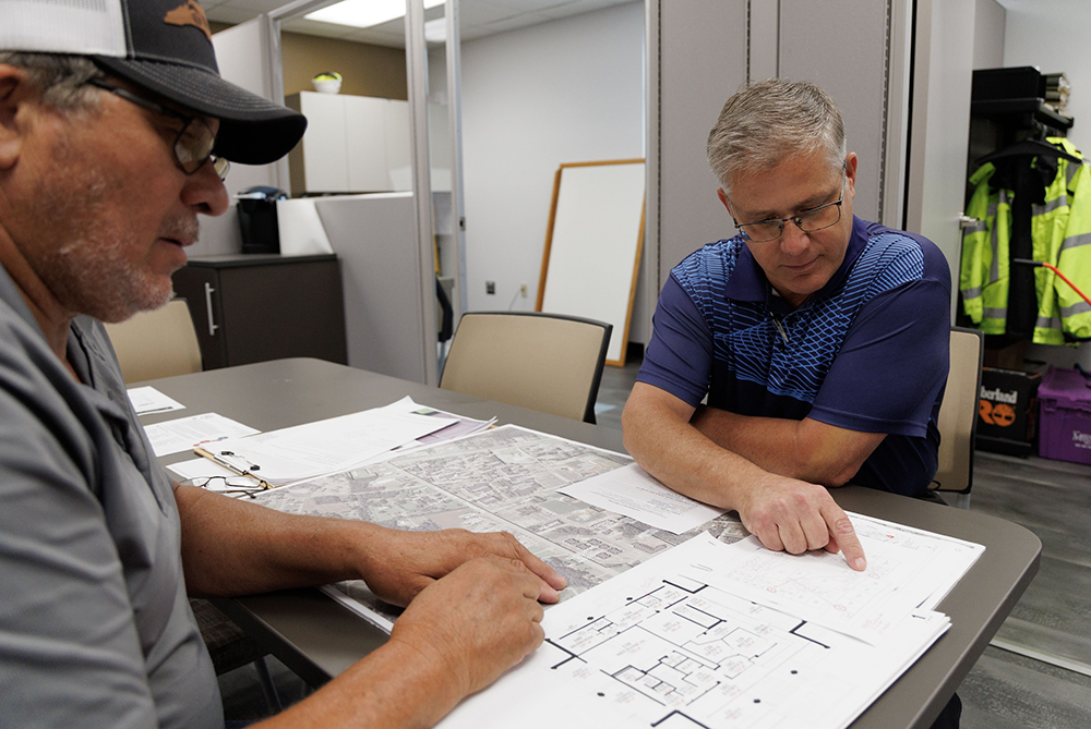 facilities planning staff with drawings