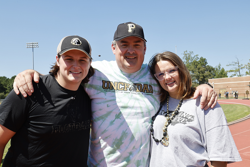 UNCP students, brother and sister, with their dad