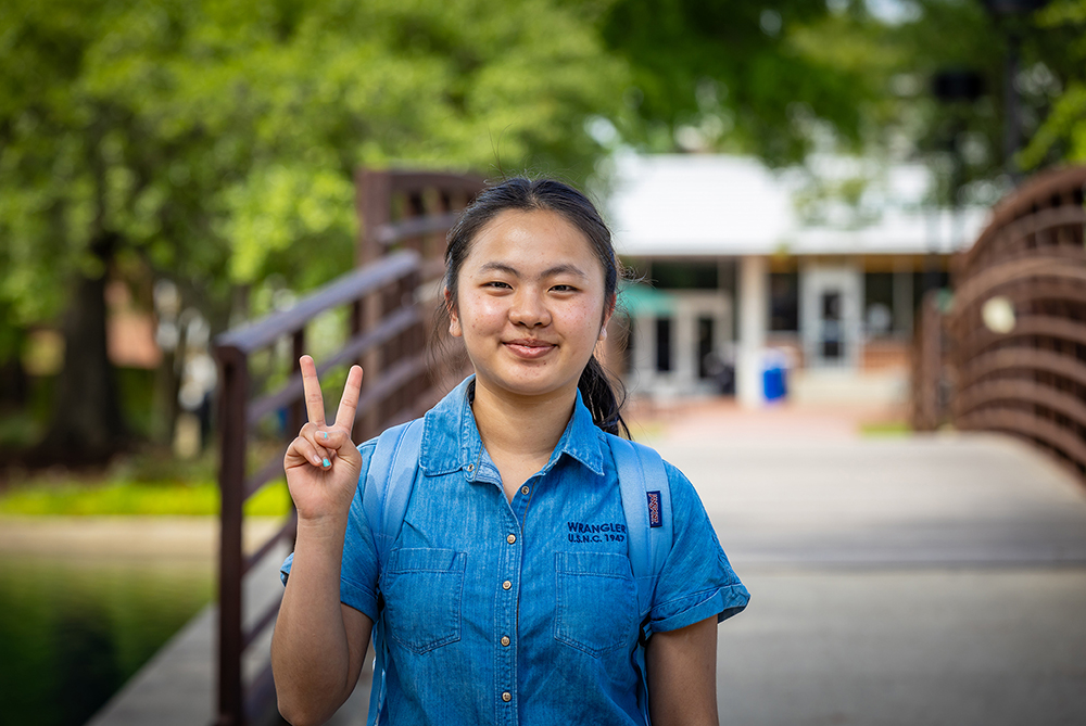 female student at bridge on UNCP campus
