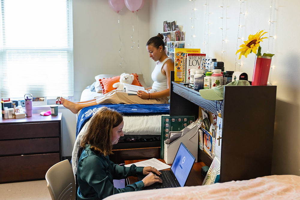 Roommates in their room studying together