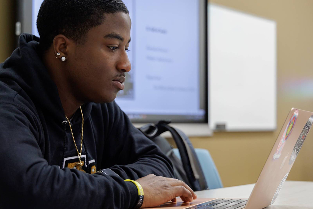 UNCP student looking at computer