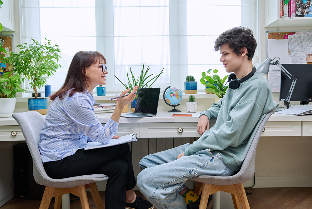 female school counselor talking with teen student