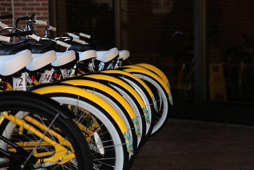 Yellow bike share bikes outside of the Chavis Student Center