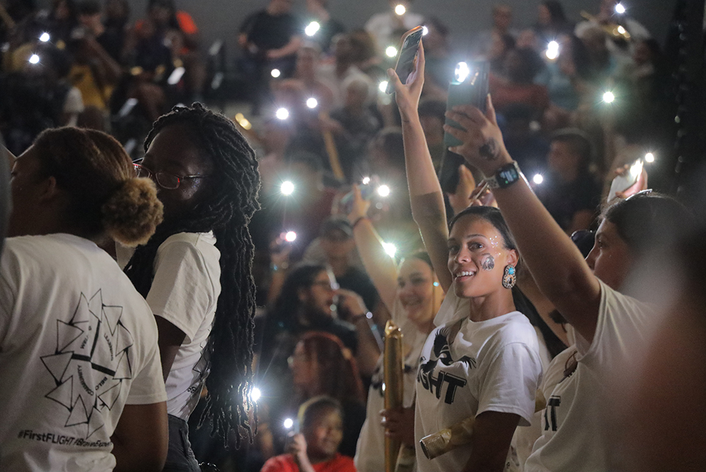 Students with cell phone lights cheering at UNCP's Black & Gold Kick-Off