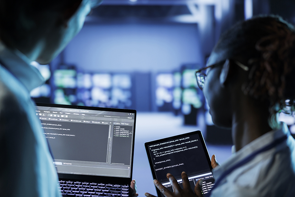 image of a young female with a computer in a blue lit room