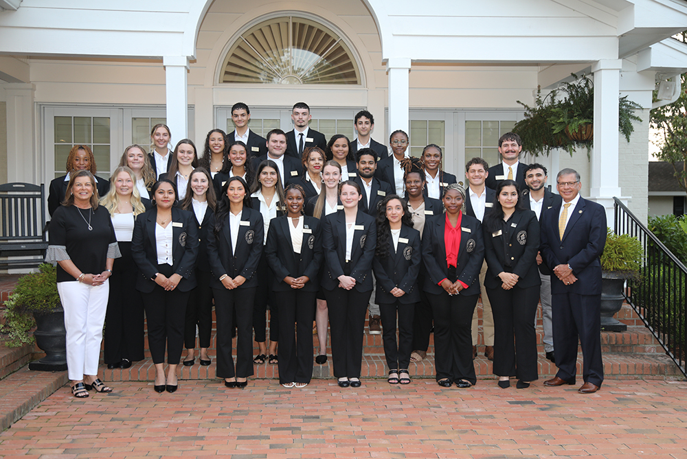 Group of student ambassadors standing with the UNCP Chancellor Dr. Robin Gary Cummings