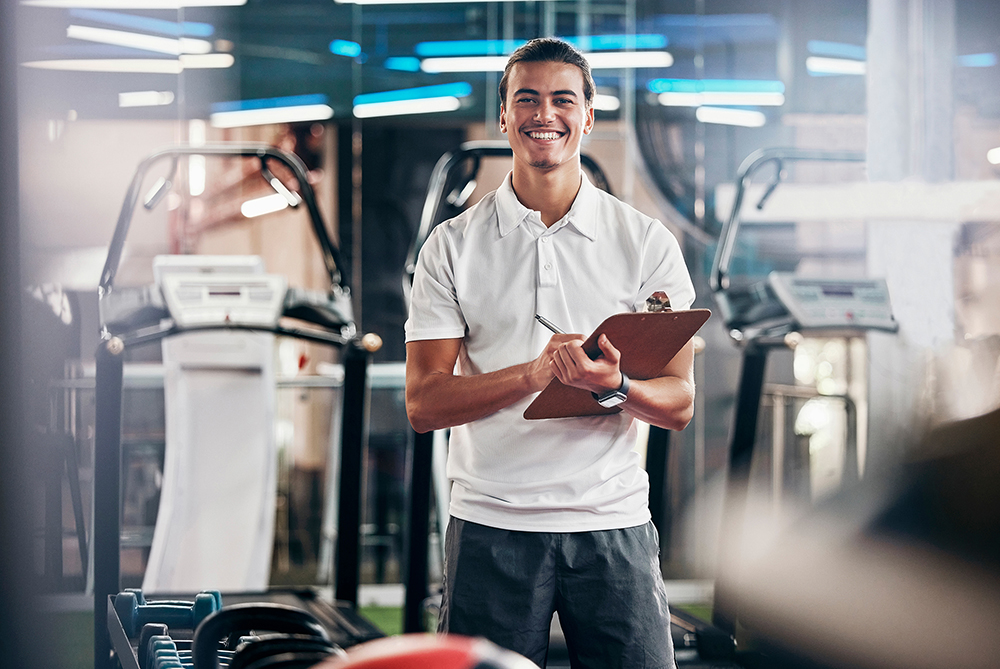 man in gym with clipboard