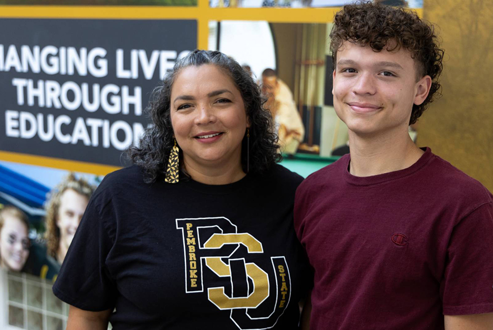 male standing with mom in Student Center