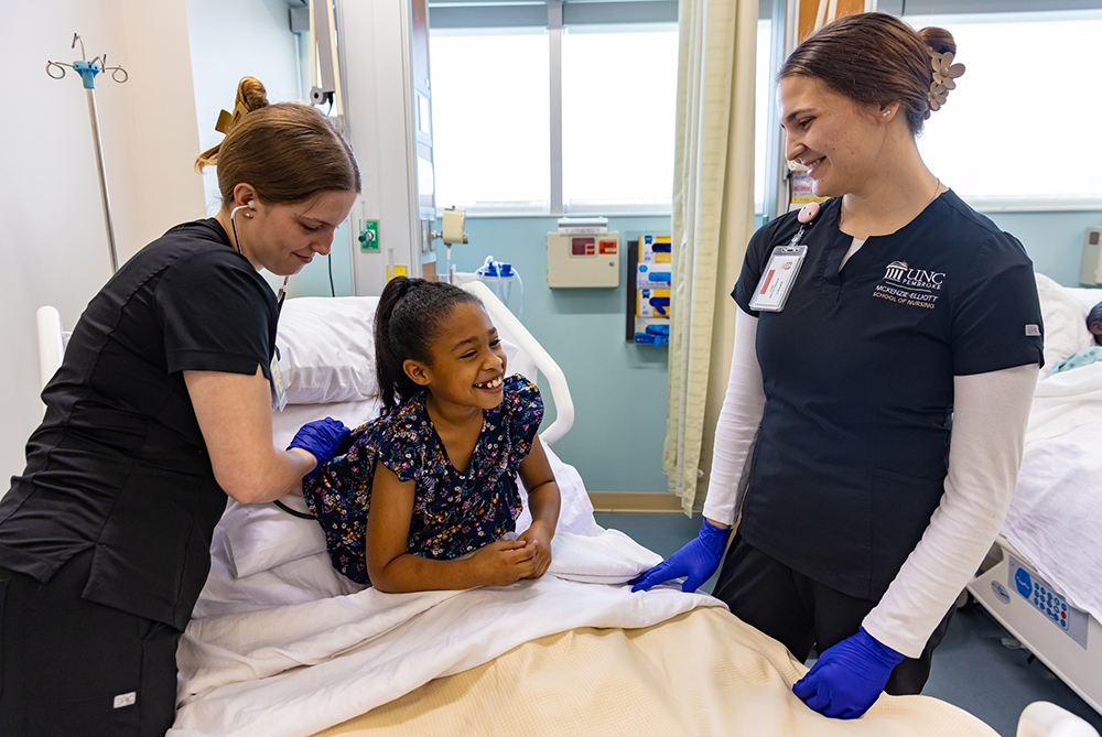 UNCP Nursing students with child in simulation lab