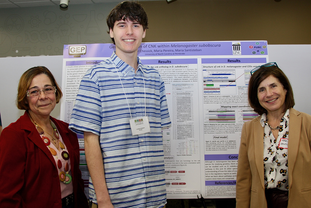 PURC symposium biology faculty with student in front of research poster