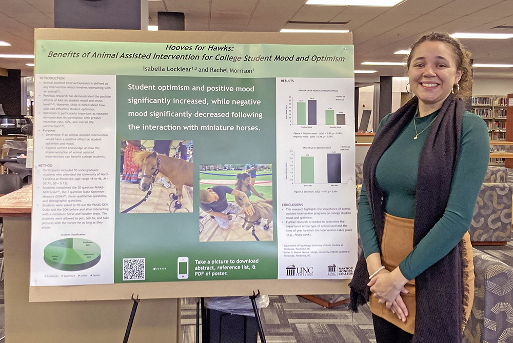 student with research poster at UNCP