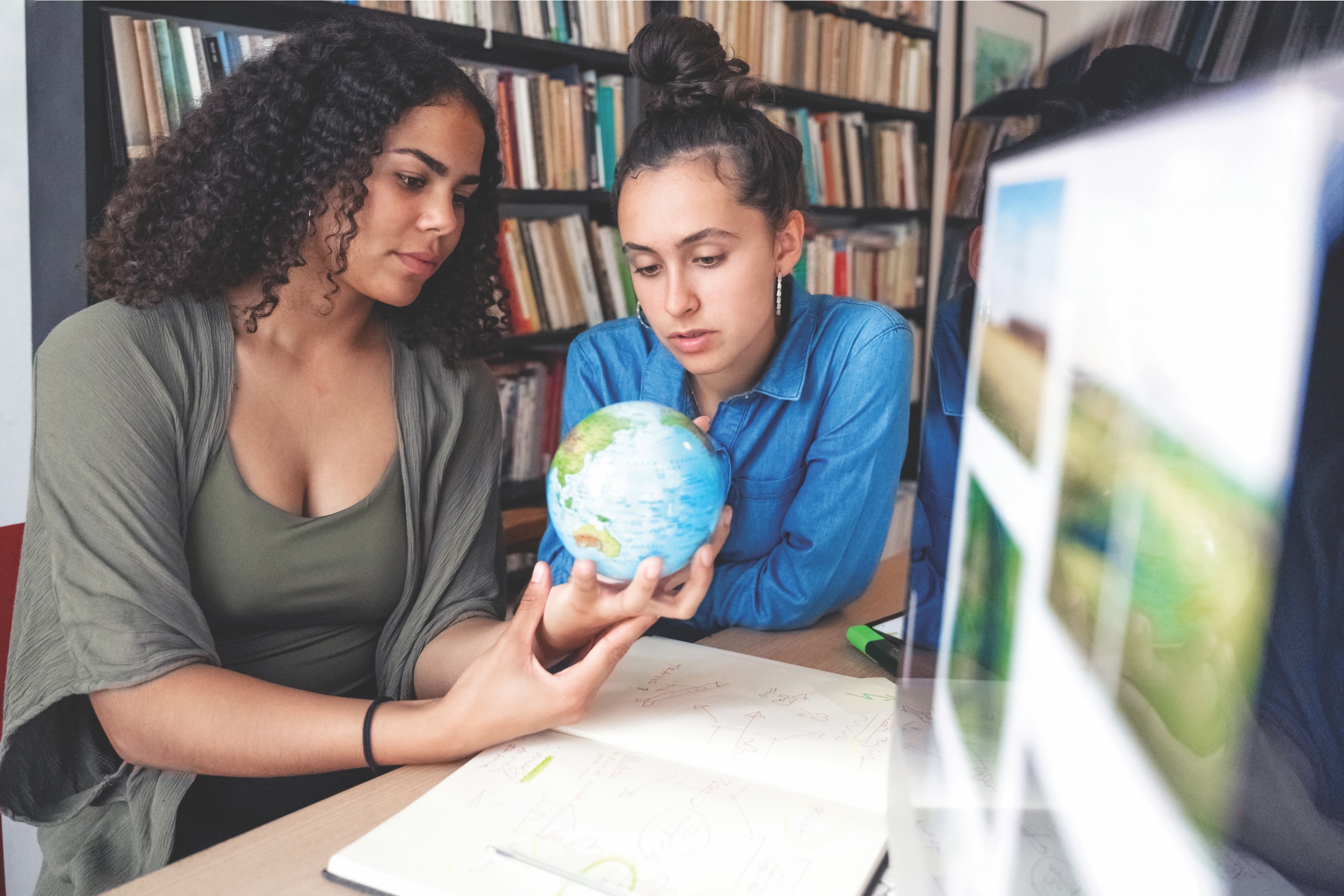 females looking at globe