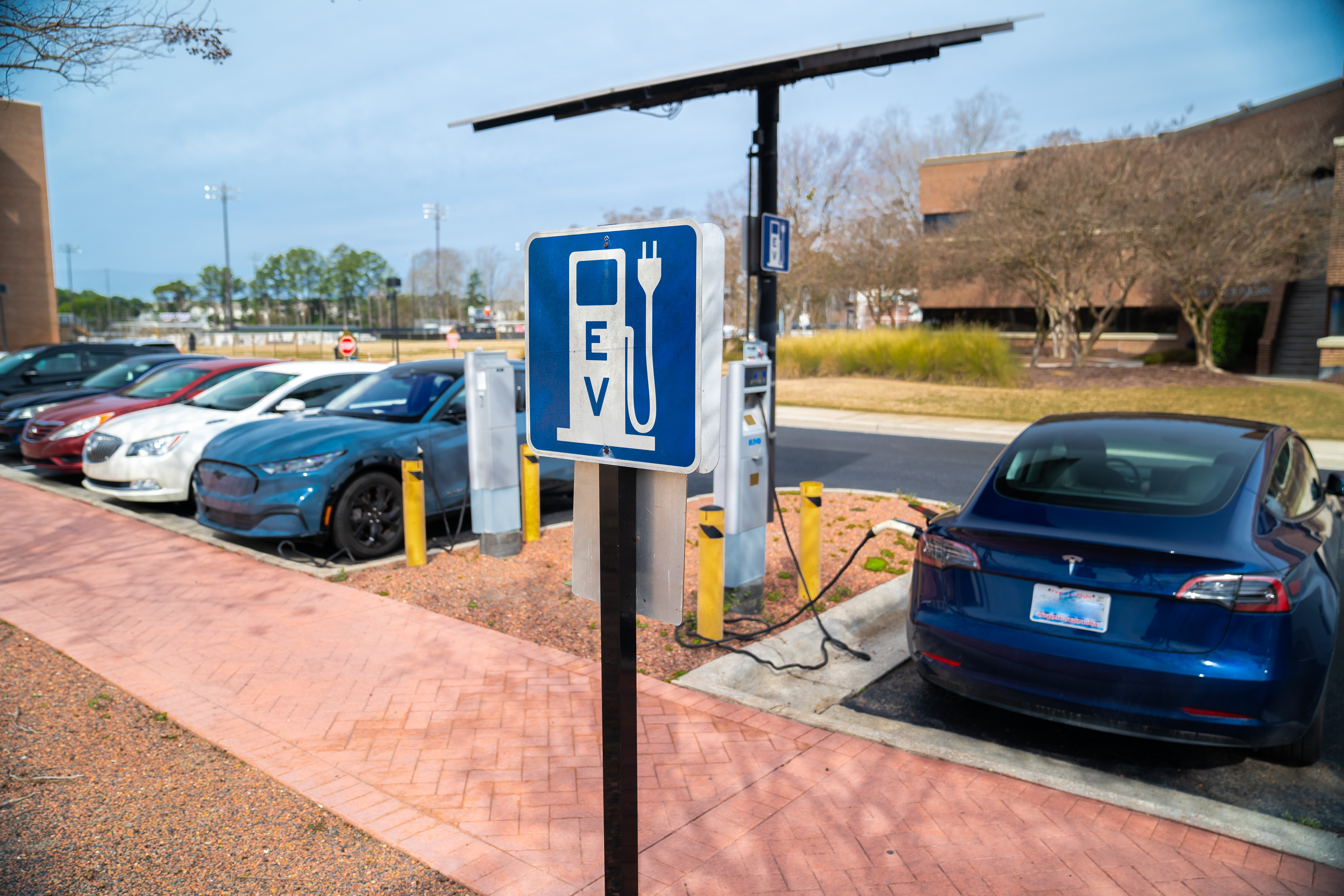 Electric vehicles parked at the charging station in front of Lumbee Hall at UNCP