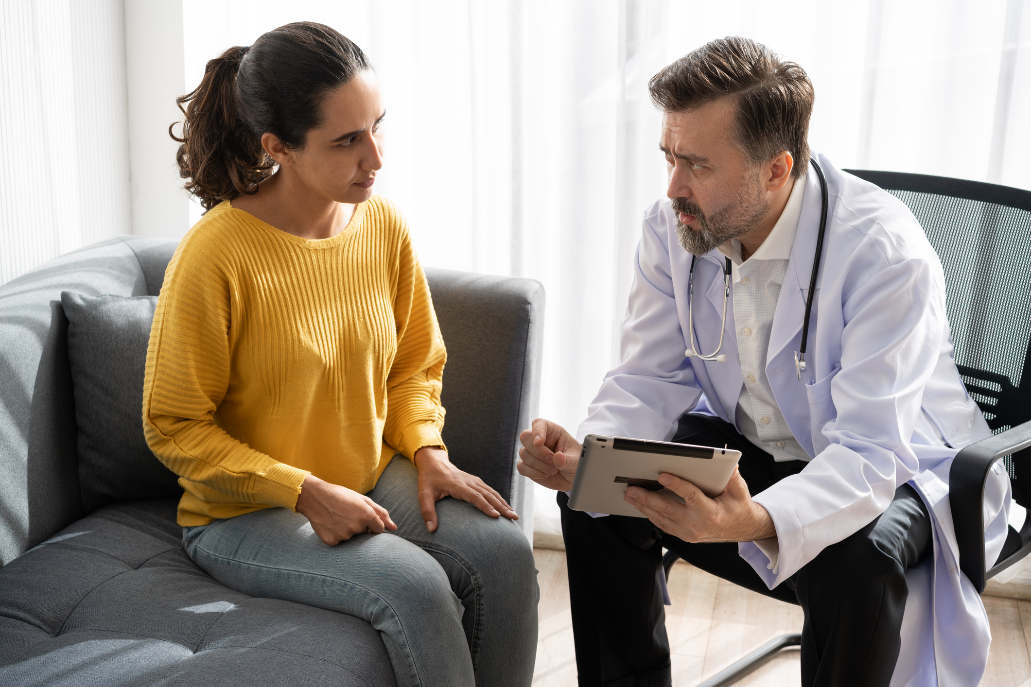 female patient with male doctor in white coat
