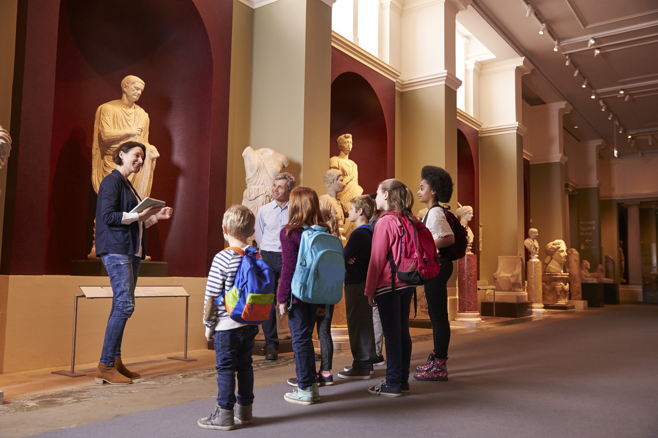 history teacher with students at museum